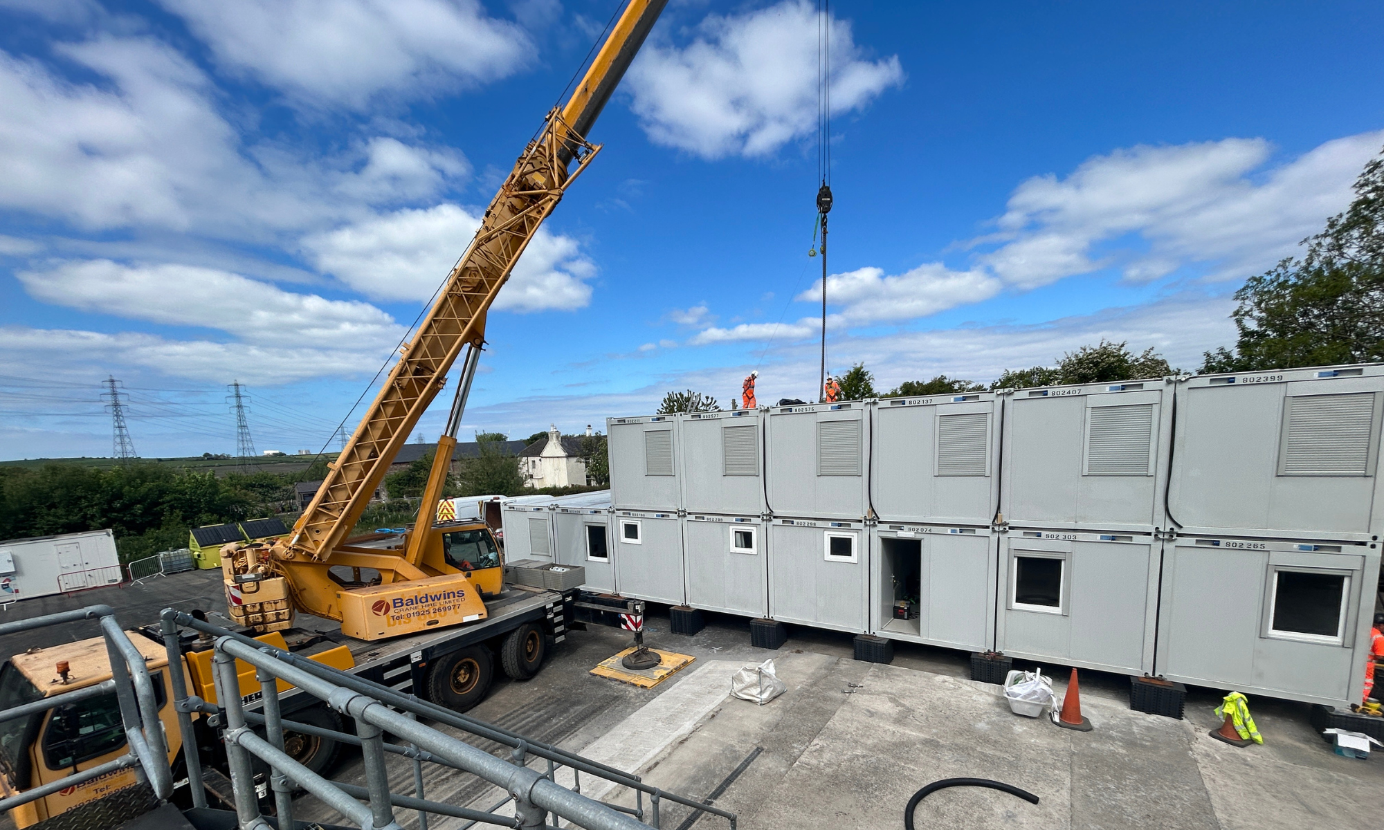 Crane lifting accommodation units on a construction site