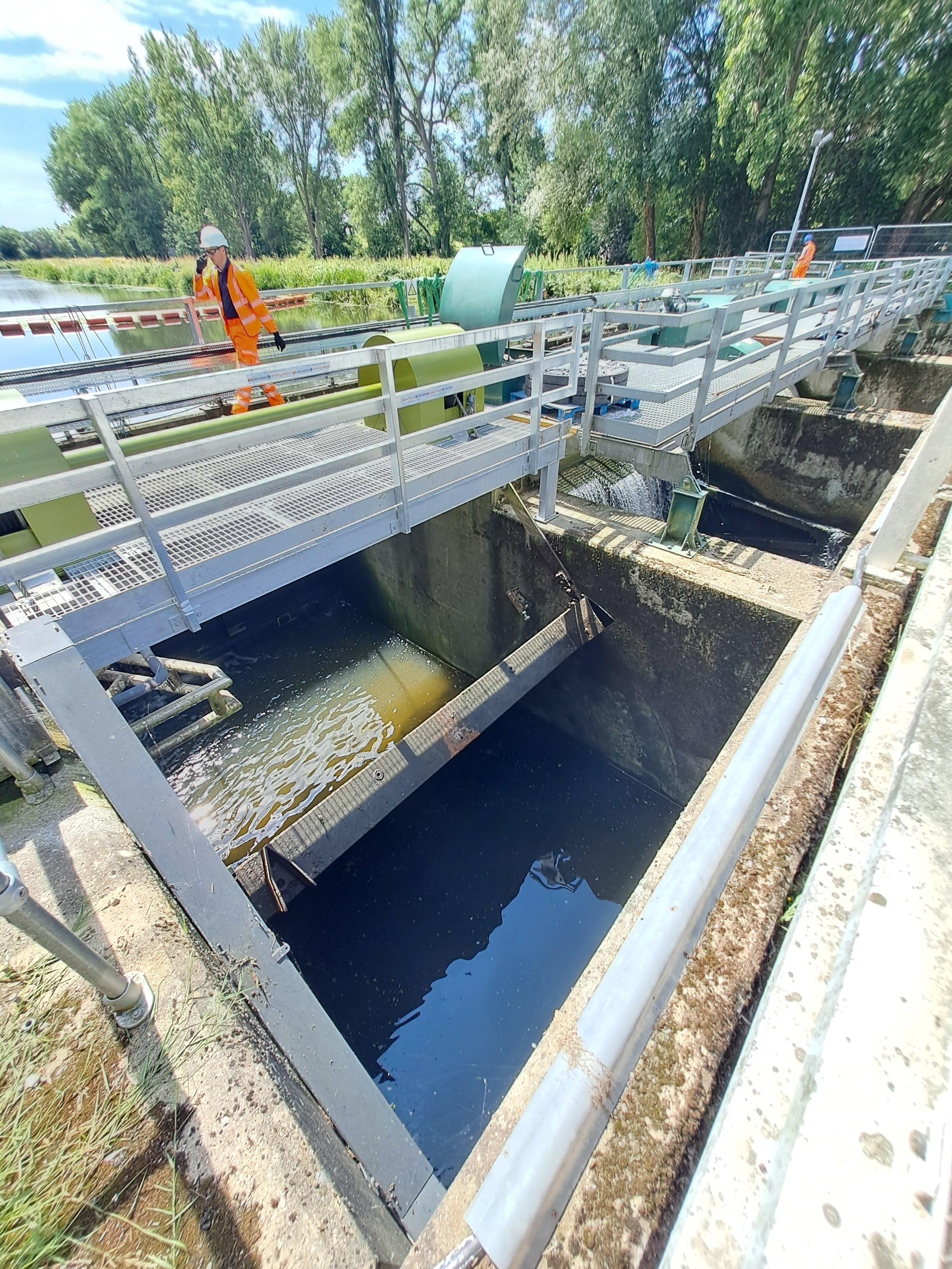 A man walking over a bridge.
