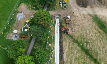 Picture of a field with a dumper truck.