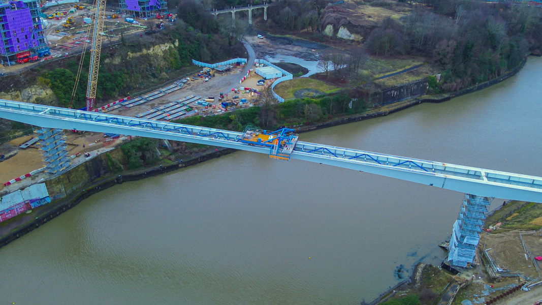 Picture of a steel bridge going across the water.
