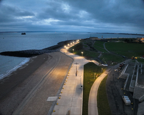 Promenade by the seafront with lights down the side.