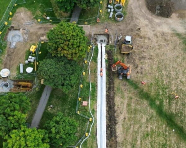 Picture of a field with a dumper truck.