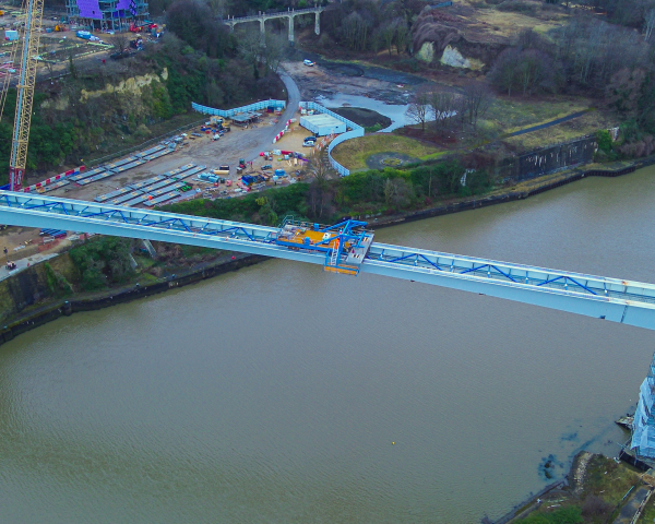 Picture of a steel bridge going across the water.