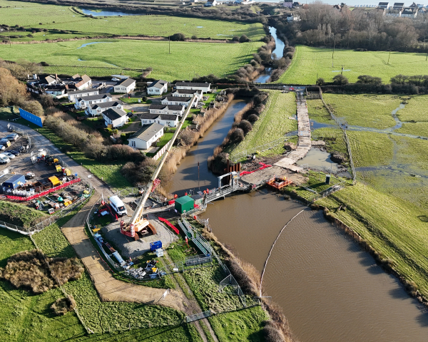 Aerial view of work taking place over a river
