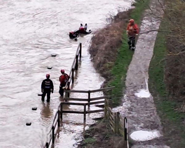 People in a river practicing safety training.
