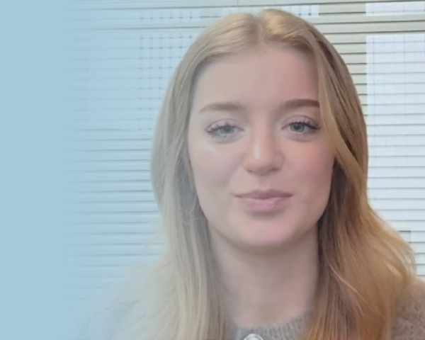 Girl smiling at camera in an office.