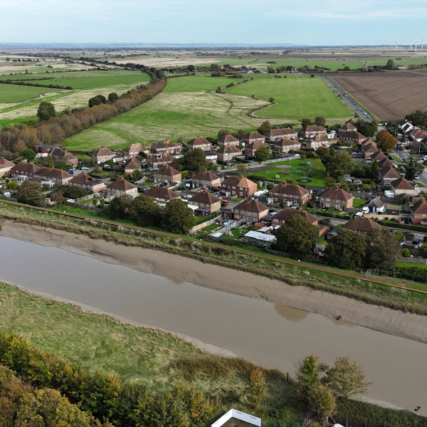 Picture of a river running in front of houses.