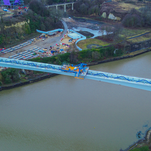 Picture of a steel bridge going across the water.