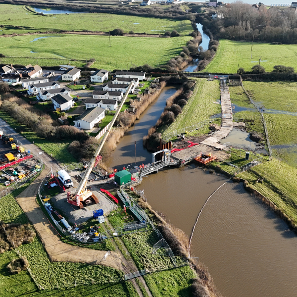 Picture of a river with a bridge and crane.