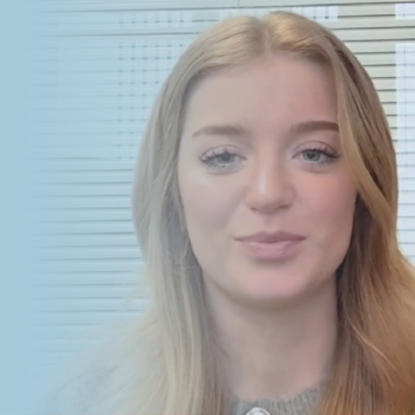 Girl smiling at camera in an office.